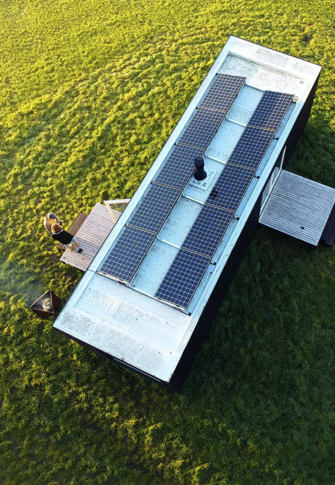 Ark-Shelter built in a grass plane, with solar panels in the roof